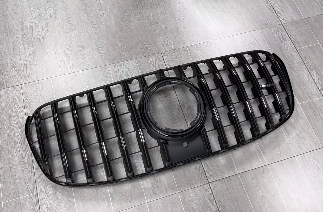 Uninstalled gloss black AMG GT style Panamericana front grille replacement for the facelifted 2024-2026 Mercedes Benz GLS450 and GLS580 X167, featuring factory camera and emblem cutouts.