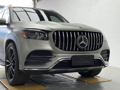 Low angle shot of a matte grey Mercedes GLS580 4MATIC X167 demonstrating the aggressive front end look after installing the OEM fitment AMG Panamericana grille.