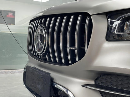 Close-up side view of the AMG GT Panamericana front grille installed on a 20-23 Mercedes GLS450 X167, highlighting the large curvature design and chrome vertical slats.