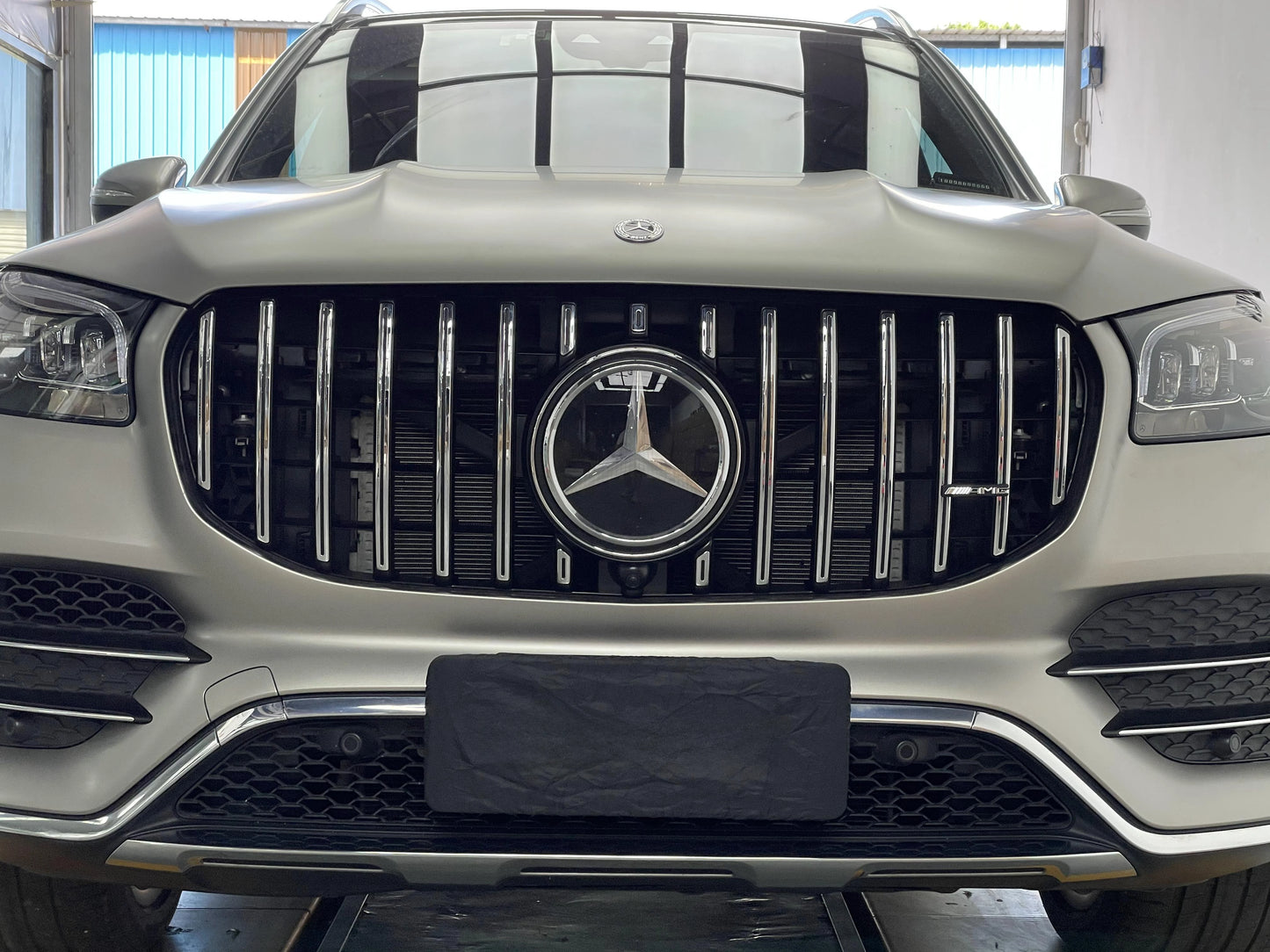 Direct front view of a 2020 to 2023 Mercedes Benz GLS450 X167 equipped with a custom AMG GT style Panamericana front grille and center emblem.