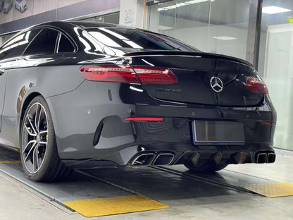 Close-up of E63 AMG style rear diffuser and quad exhaust tips fitment on Mercedes E350 Coupe W213