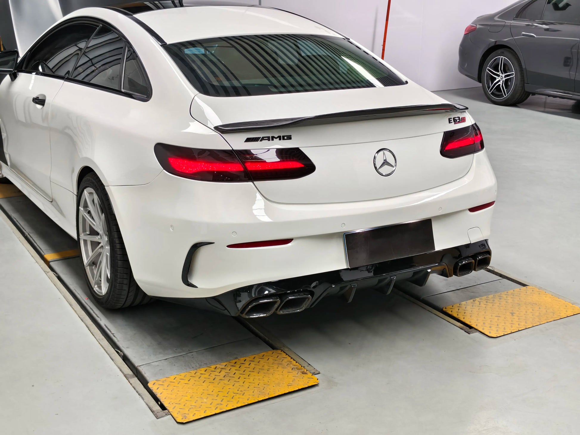 Rear side view of 2021-2023 Mercedes W213 E350 Coupe featuring E63 AMG style widebody kit and custom stance