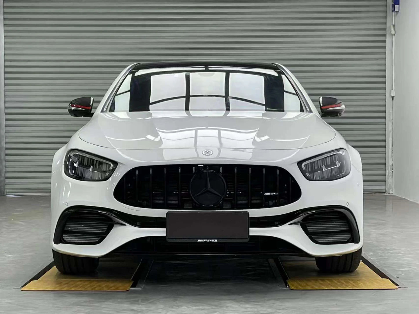 Close-up view of E63 AMG style custom engine hood on Mercedes W213 E450 Coupe